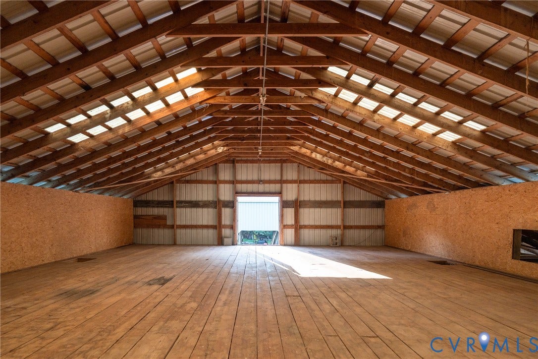 The spacious hay loft provides exceptional storage and future-use potential.