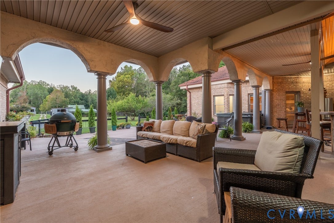 The covered outdoor living area creates a comfortable place to relax while overlooking the farm.