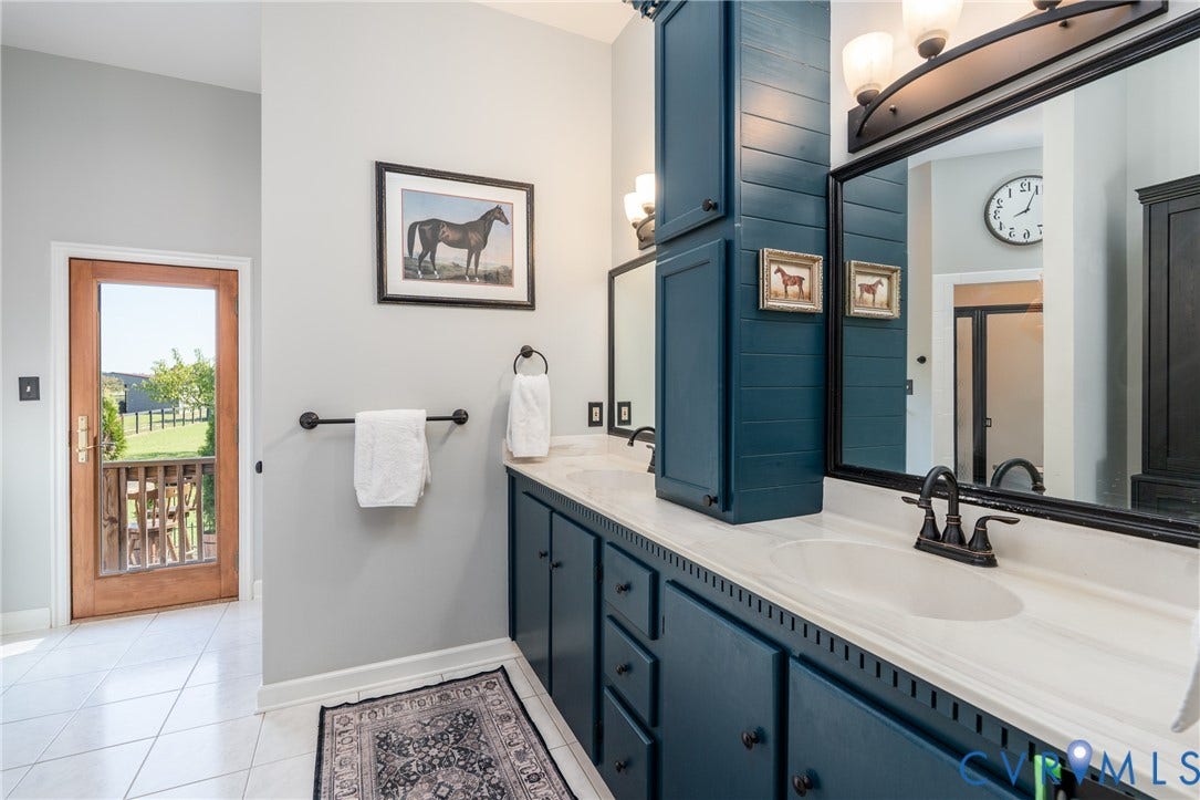 Primary Bathroom with dual vanity, soaking tub, and shower with two shower heads.