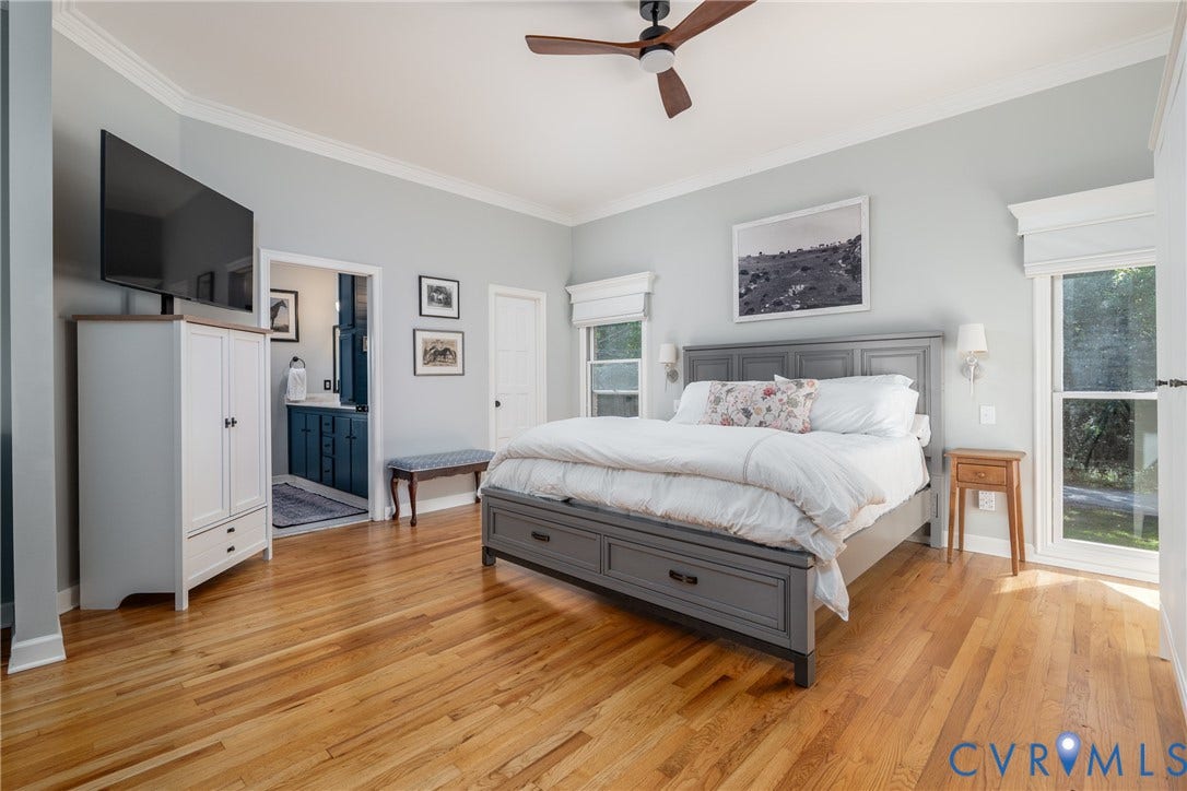 The primary bedroom and walk-in closet is spacious and filled with natural light.
