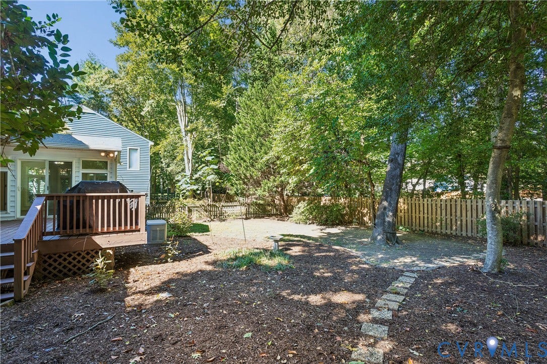 Wood deck with railing, private backyard, mature trees, privacy fence, exterior siding