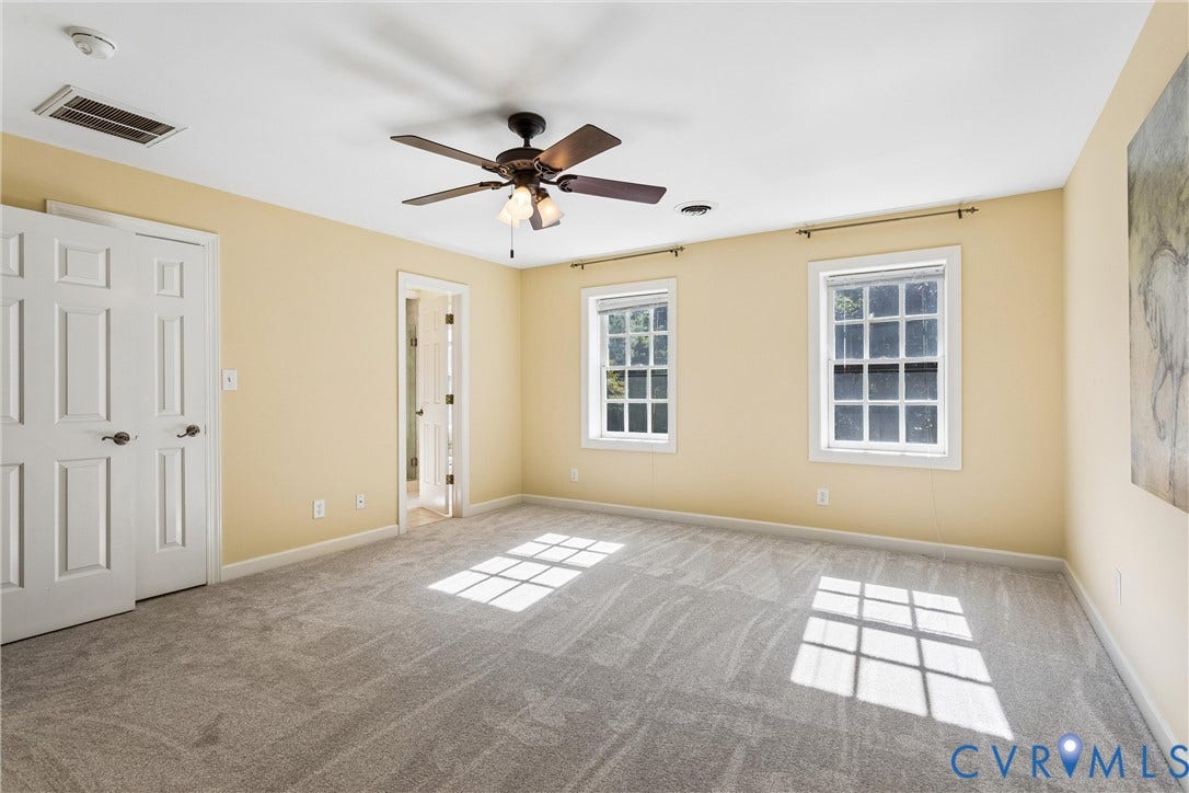 Bright and spacious room flooded with natural light through dual double-hung windows