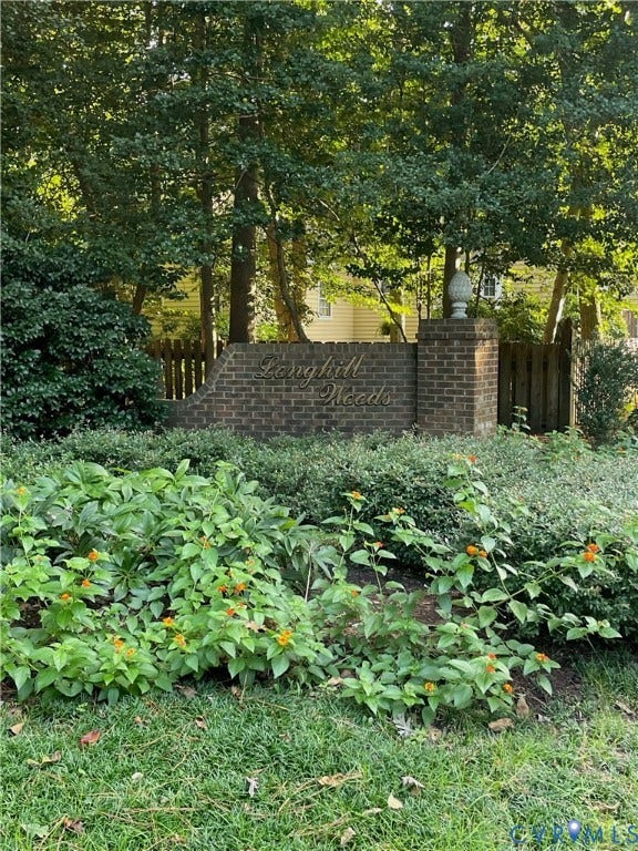 Brick entrance monument featuring an ornamental finial