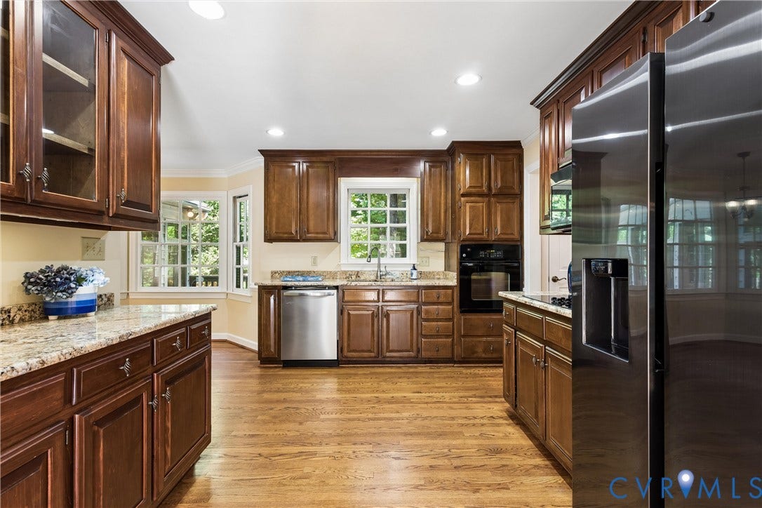 Hardwood flooring, wood cabinetry, stone countertops, stainless steel appliances, and recessed lighting