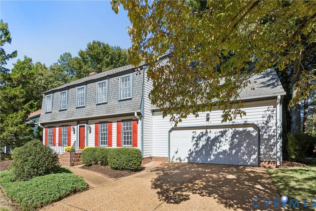 Dormer-style colonial exterior with a two-car garage
