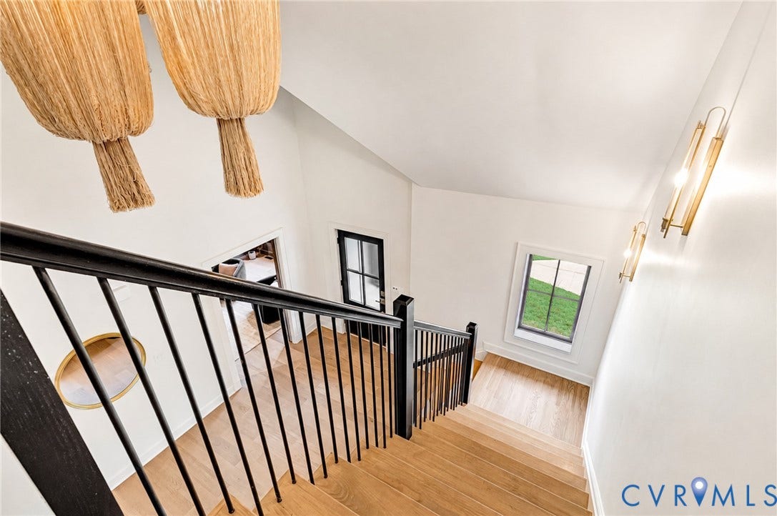 404 Waveny Road, Westham, Henrico, VA 23229 Staircase featuring wood-finish treads, matte black metal balusters, and a vaulted ceiling