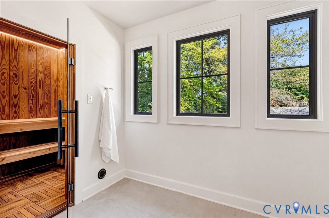 404 Waveny Road, Westham, Henrico, VA 23229 Custom built-in sauna with wood-panel detailing, glass door entry, and integrated lighting, complemented by large-format tile flooring and mullioned windows with black frames