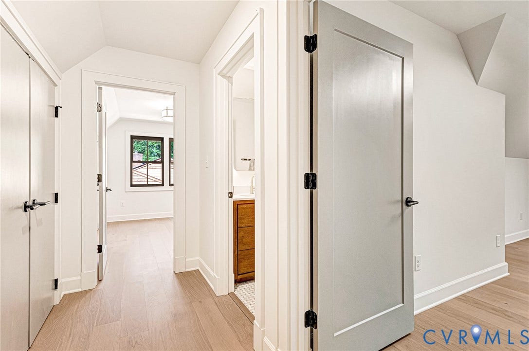 404 Waveny Road, Westham, Henrico, VA 23229 Interior hall featuring light-tone wood-finish flooring, shaker-style interior doors, matte black hardware, and crisp white trim