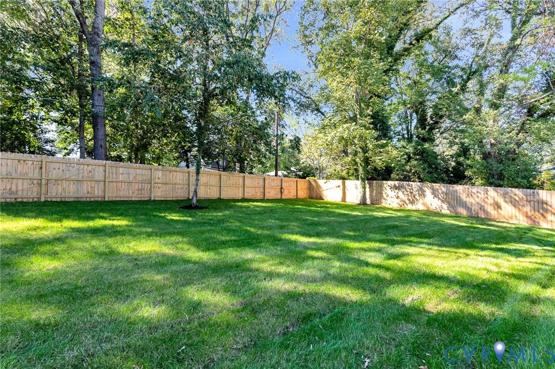 404 Waveny Road, Westham, Henrico, VA 23229 Fenced backyard featuring a manicured lawn and mature trees