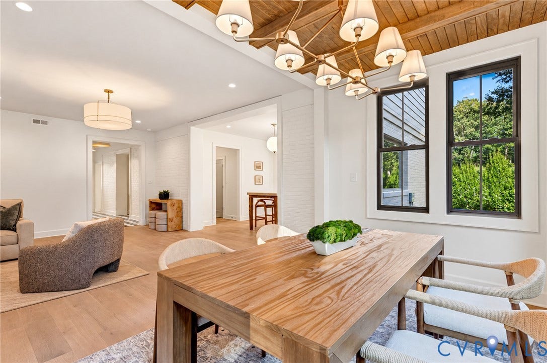 404 Waveny Road, Westham, Henrico, VA 23229 Wood-plank ceiling with exposed beams, custom multi-light chandelier, wood-finish flooring, and crisp white-painted brick accent walls