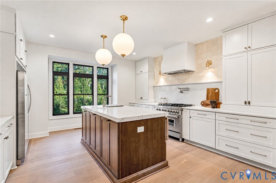 404 Waveny Road, Westham, Henrico, VA 23229 Gourmet kitchen featuring custom cabinetry, a contrasting center island with stone-surface countertop, high-end stainless steel range, textured tile backsplash, and wood-finish flooring