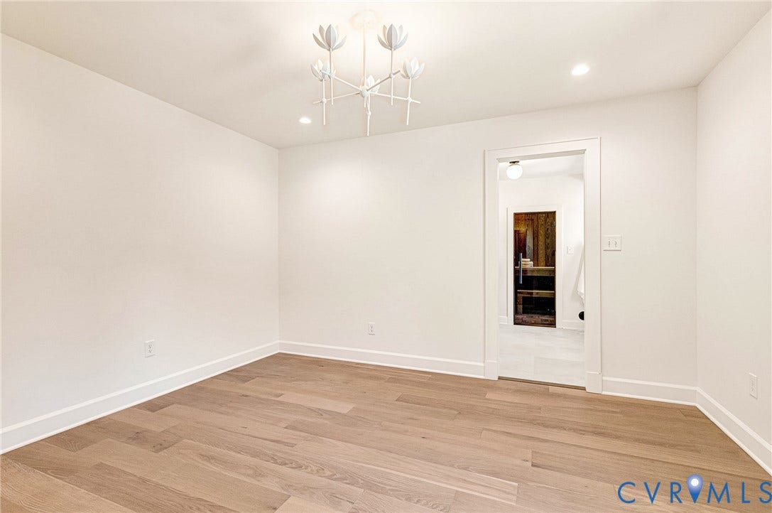 404 Waveny Road, Westham, Henrico, VA 23229 Wood-finish flooring, multi-arm floral-inspired chandelier, recessed ceiling lighting, and crisp white wall finishes