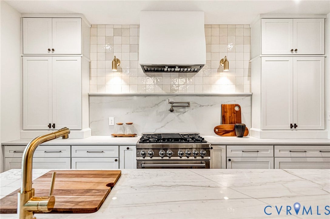 404 Waveny Road, Westham, Henrico, VA 23229 Kitchen featuring floor-to-ceiling Shaker-style cabinetry, a custom range hood, square-tiled backsplash, stone-look countertops, and a professional-grade gas range with a wall-mounted pot filler