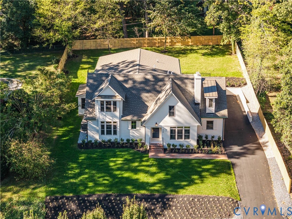 404 Waveny Road, Westham, Henrico, VA 23229 Custom-built residence featuring a white exterior, steep gable roofline, exterior brick walkway, asphalt driveway, and enclosed perimeter fencing