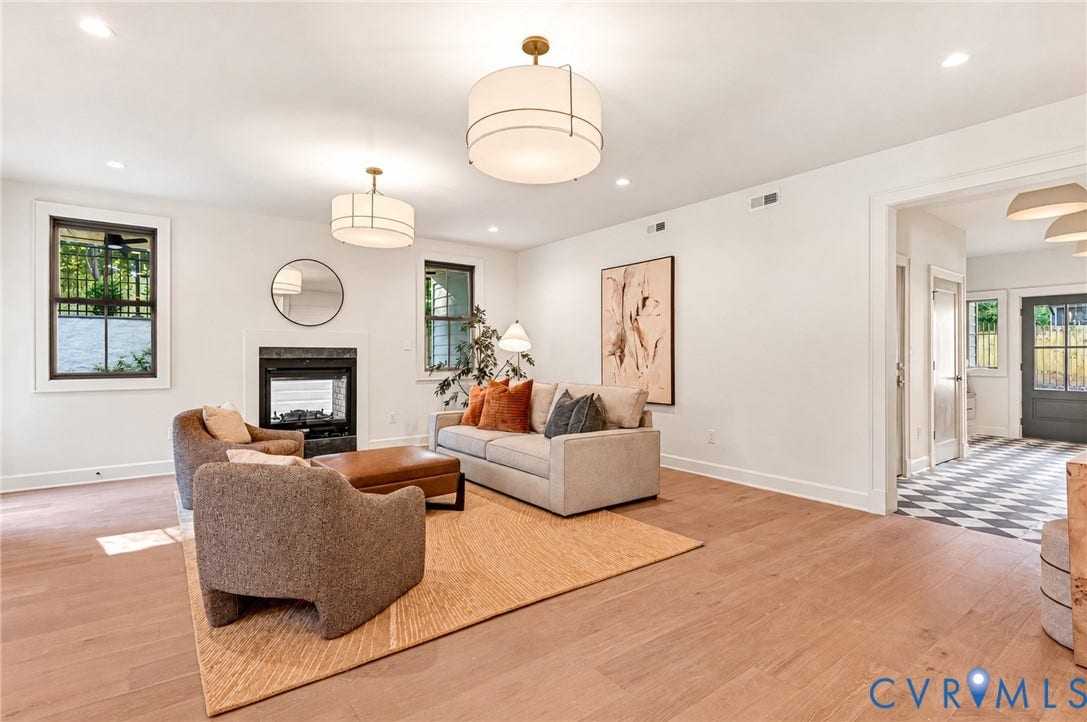 404 Waveny Road, Westham, Henrico, VA 23229 Living area featuring wood-finish flooring, two large drum-style pendant light fixtures, a fireplace with a dark stone surround, and recessed lighting