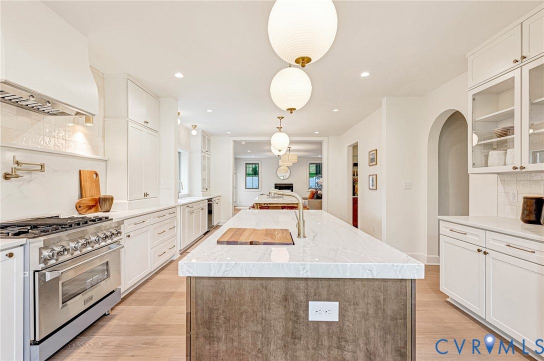 404 Waveny Road, Westham, Henrico, VA 23229 Kitchen featuring a central island with a stone countertop, custom white cabinetry, a professional-grade stainless steel range with a pot filler, wood-finish flooring, and globe pendant lighting