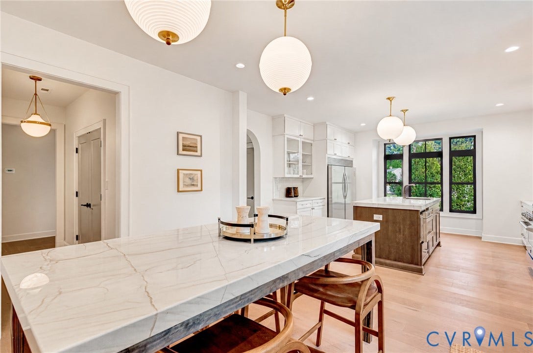 404 Waveny Road, Westham, Henrico, VA 23229 Kitchen featuring an island with a white stone-surface countertop, wood-finish cabinetry, recessed lighting, spherical pendant fixtures, and large windows with black frames