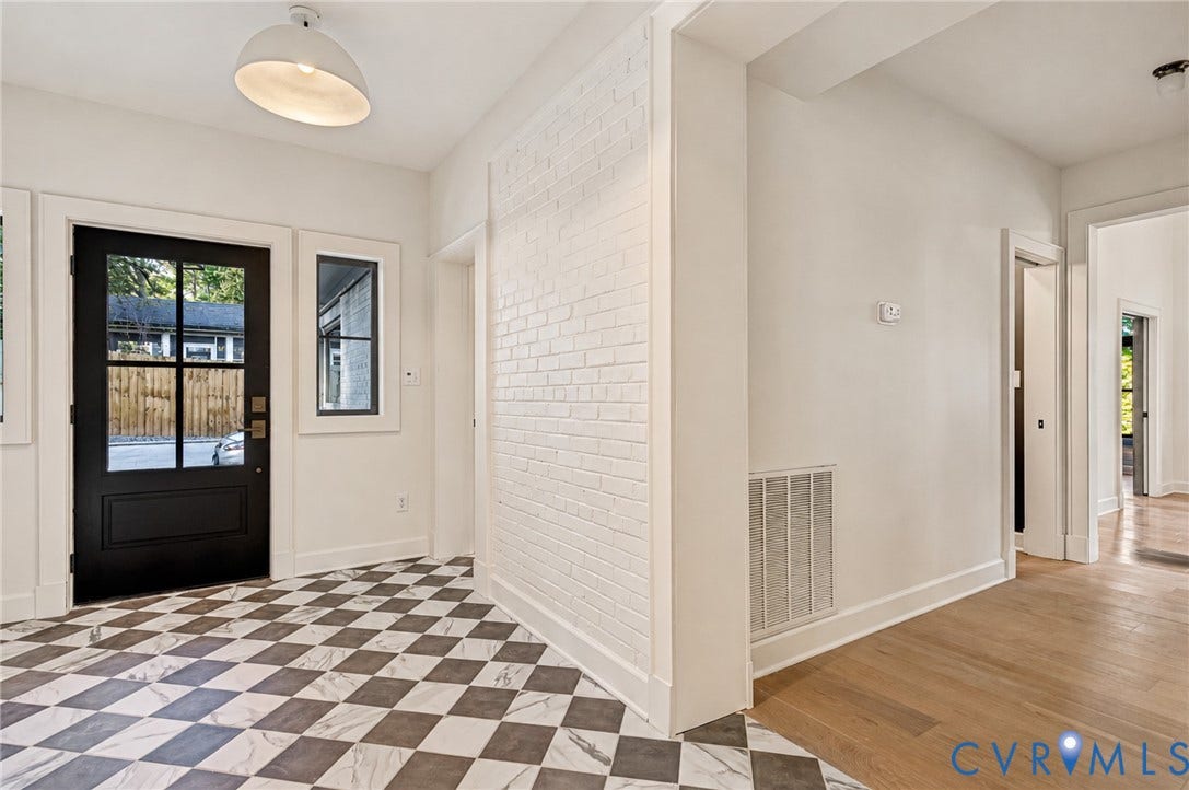 404 Waveny Road, Westham, Henrico, VA 23229 Entryway featuring black-framed multi-pane front door, checkerboard pattern tile flooring, wood-finish flooring, and white-painted brick accent wall with dome pendant lighting