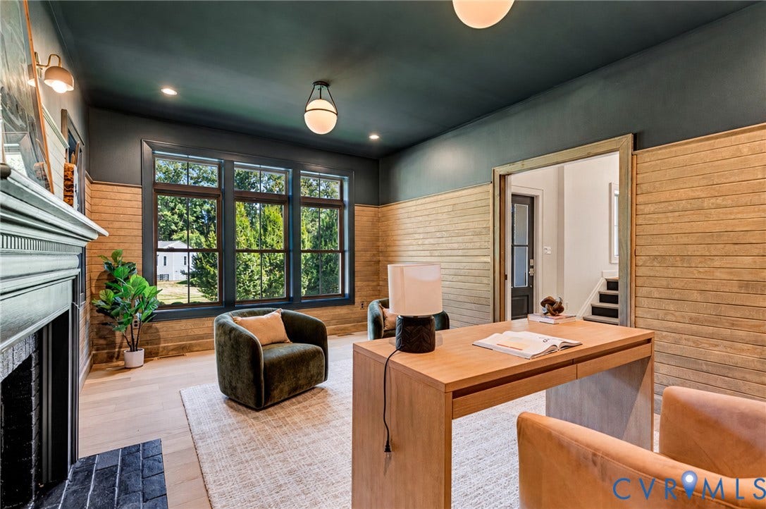 404 Waveny Road, Westham, Henrico, VA 23229 Custom room featuring horizontal wood-plank wall treatment, expansive multi-pane windows, wood-finish flooring, a brick fireplace surround, and recessed and globe-style lighting