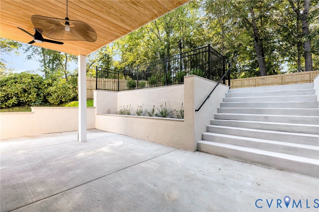 404 Waveny Road, Westham, Henrico, VA 23229 Covered concrete patio featuring a wood-finished ceiling, overhead lighting, integrated retaining walls, and a staircase with a metal handrail