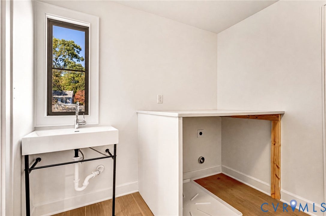 404 Waveny Road, Westham, Henrico, VA 23229 Utility area featuring a wall-mounted rectangular sink with a chrome faucet, a matte black metal console stand, and wood-finish flooring