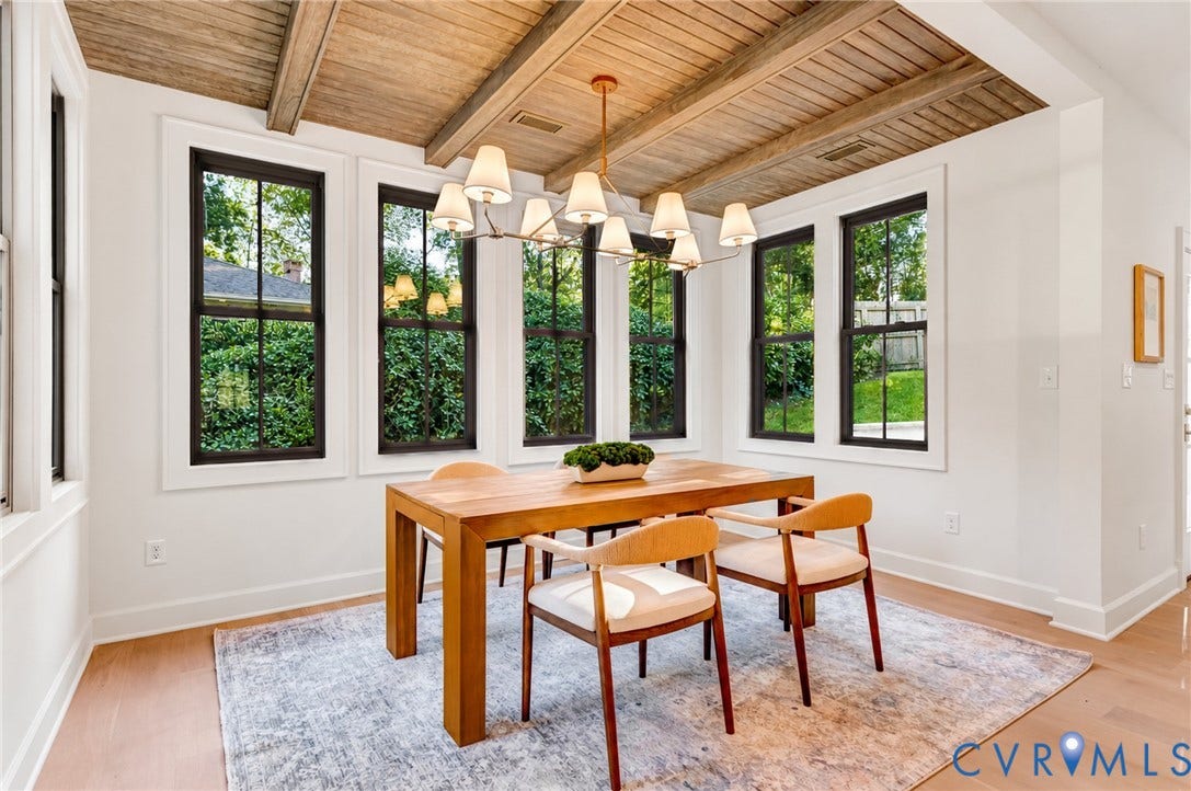 404 Waveny Road, Westham, Henrico, VA 23229 Vaulted ceiling with exposed wood beams, multi-light linear chandelier, and expansive windows with black frames