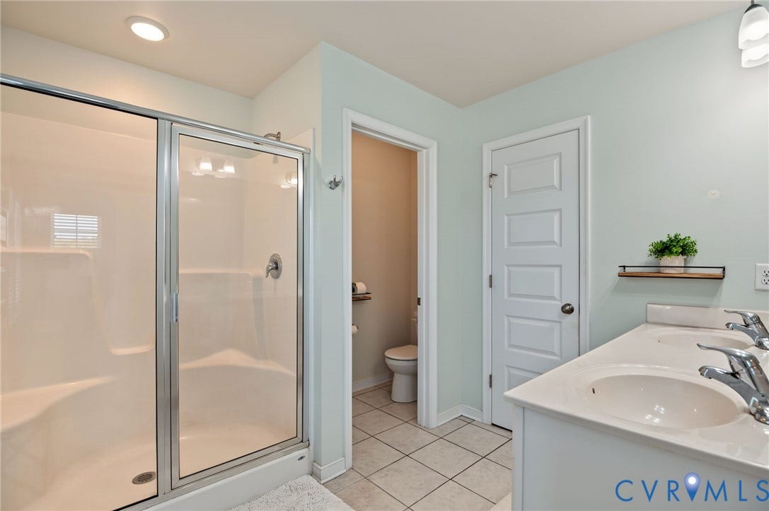 7101 Desert Candle Drive, Moseley, VA 23120 Primary bathroom, shower with glass door, and linen closet