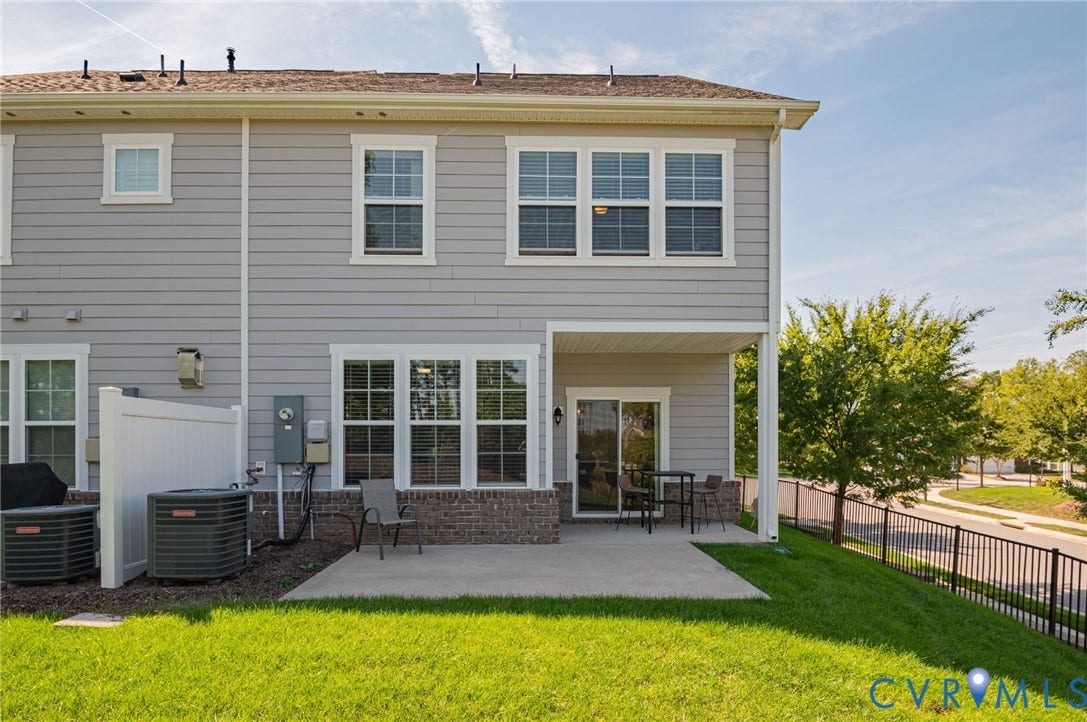 7101 Desert Candle Drive, Moseley, VA 23120 Rear exterior featuring a covered patio, sliding glass door, and a concrete patio