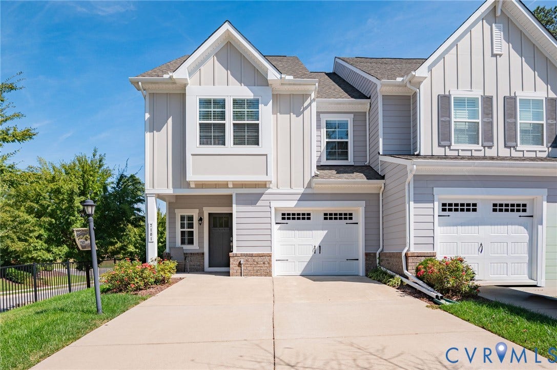 7101 Desert Candle Drive, Moseley, VA 23120 Contemporary exterior with vertical and horizontal siding, an integrated single-car garage, and a concrete driveway with oversized driveway