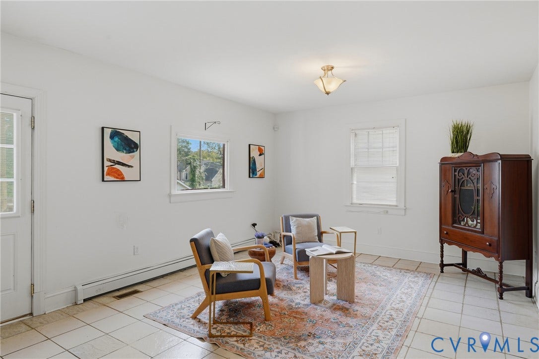 White walls, tile flooring, and multiple windows