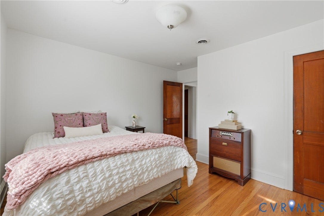 Hardwood flooring, painted walls, and wood-paneled doors