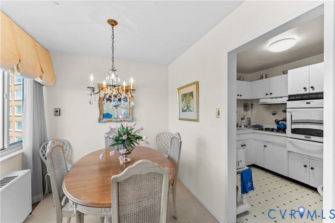 Dining area featuring a crystal chandelier and an arched doorway