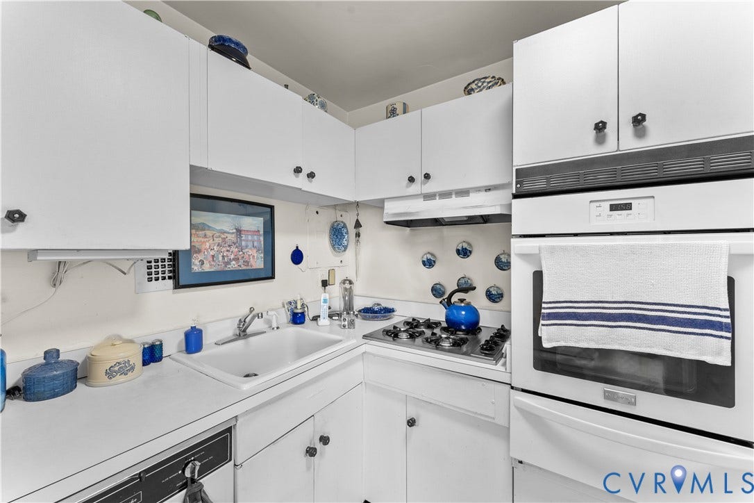White cabinetry, built-in oven, gas cooktop, integrated sink, and white countertops