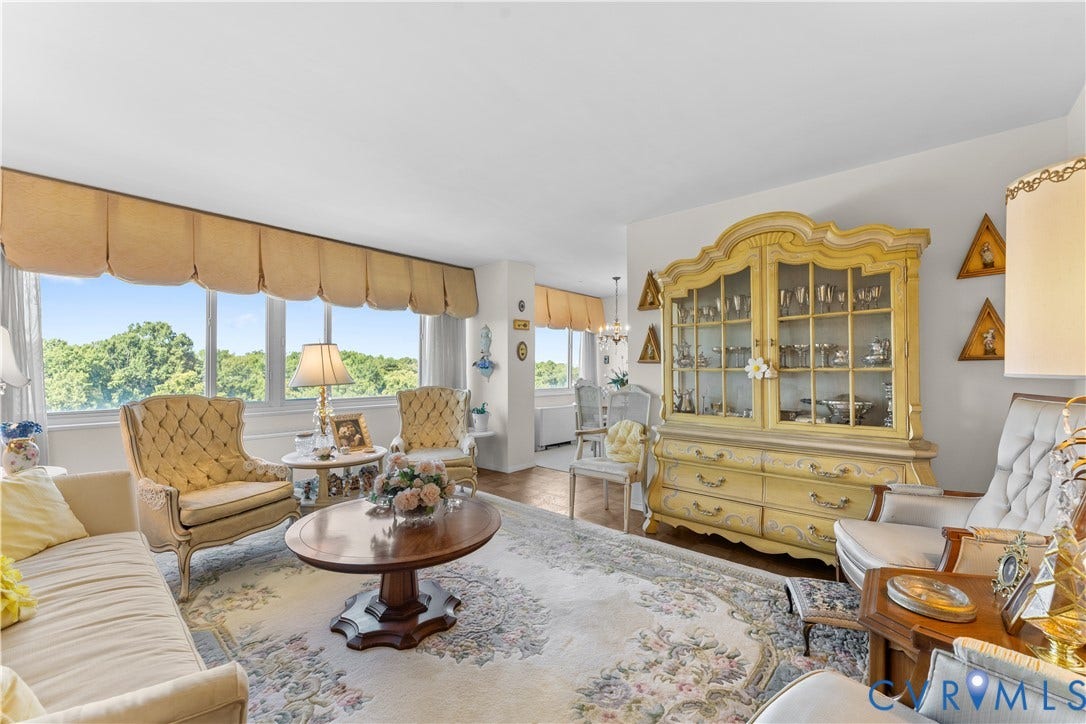 Expansive windows, wood-finish flooring, and a decorative built-in cabinet