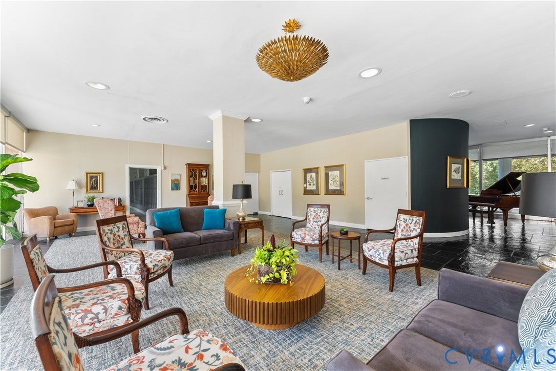 Spacious common area featuring recessed lighting, a decorative chandelier, and floor-to-ceiling windows