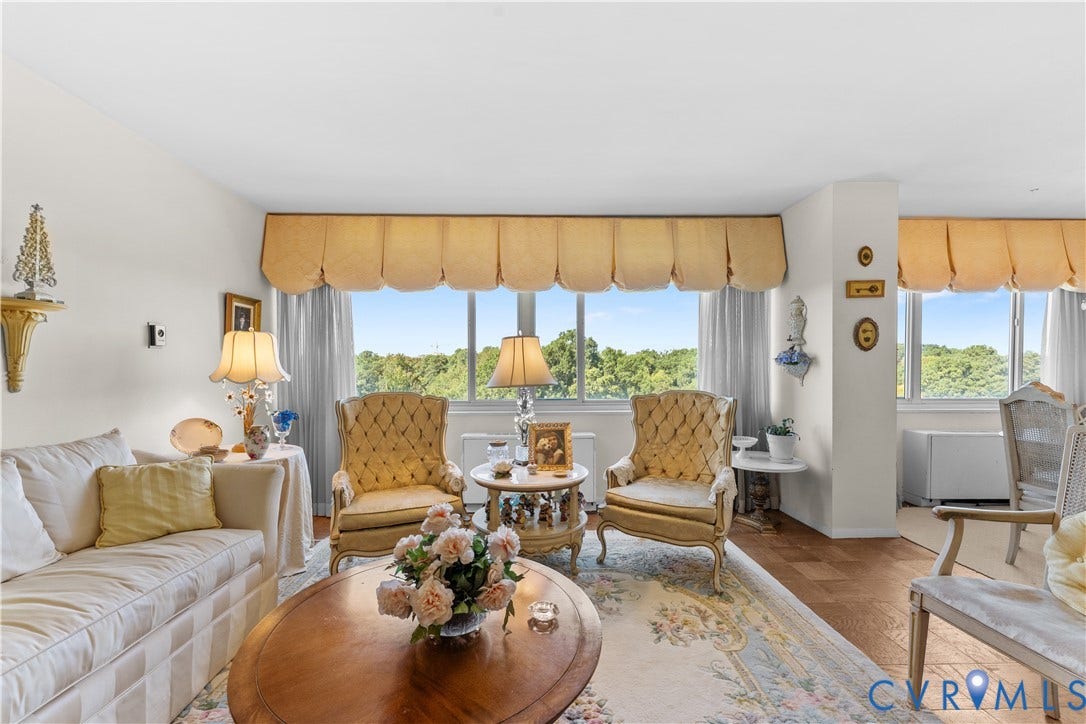 Hardwood flooring, expansive windows, window valances, and light wall finishes
