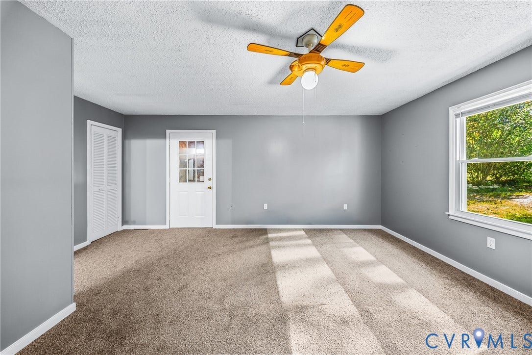 Wall-to-wall carpeting with light gray walls