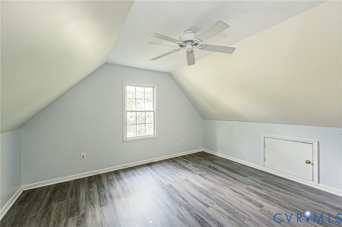 2nd floor bedroom #3 Angled ceilings with a ceiling fan, wood-finish flooring, a window, and a built-in access panel