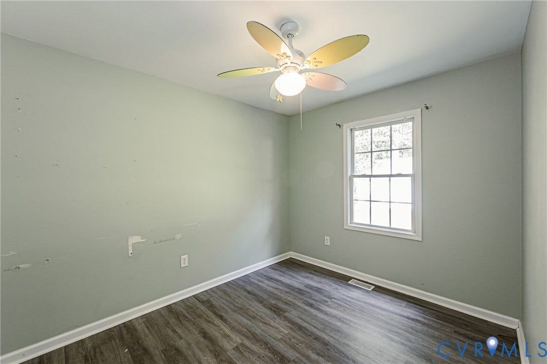 1st floor bedroom #1 Recessed ceiling lighting, wood-finish flooring, and multiple windows