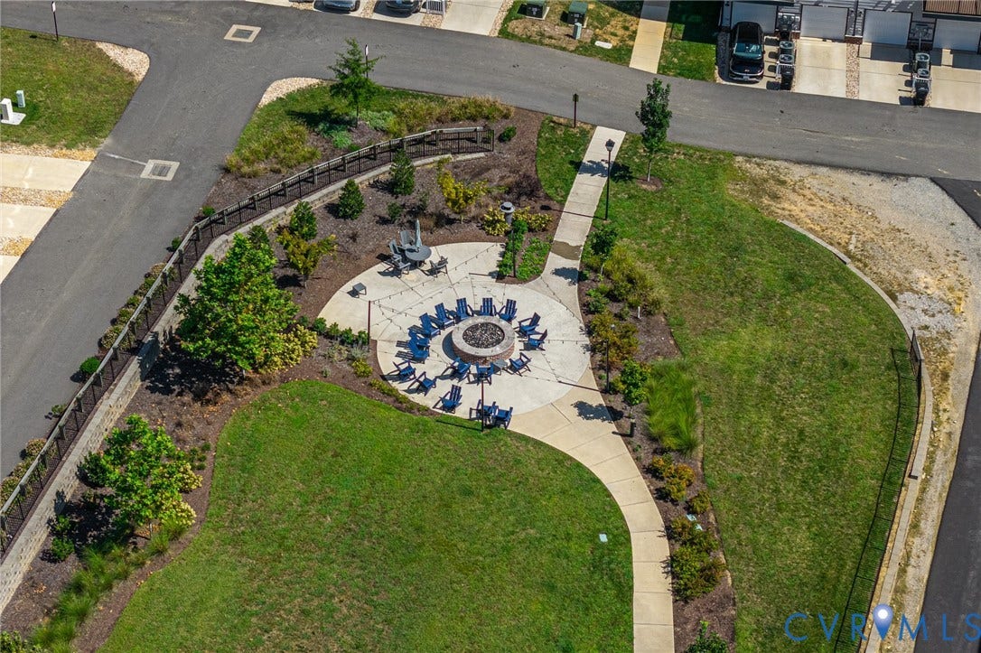 Community fire pit area with paved patio and surrounding landscaping