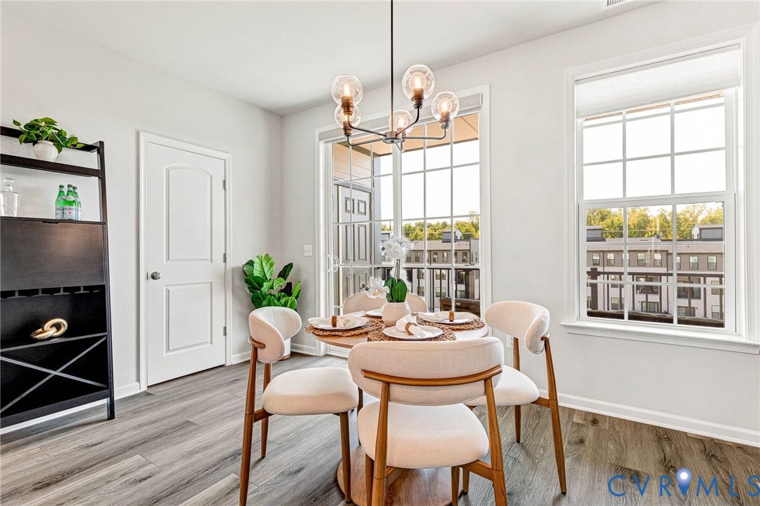 Wood-finish flooring throughout, with a built-in shelving unit featuring integrated wine storage