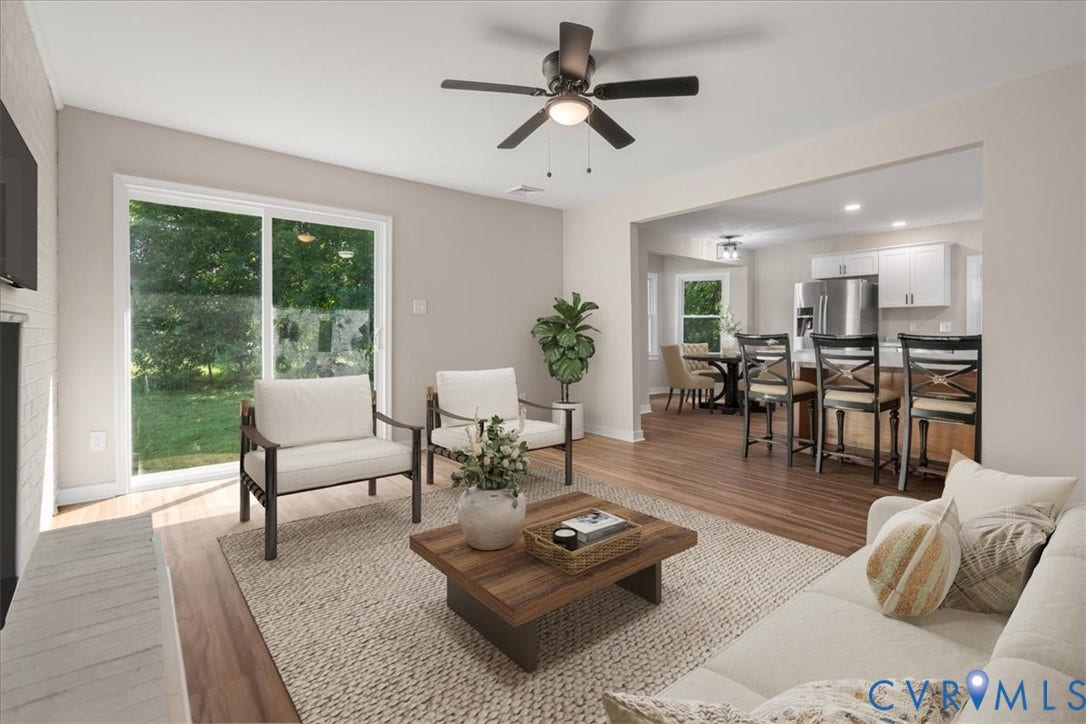 Recessed lighting, wood-finish flooring, white brick fireplace, sliding glass door, and a ceiling fan with integrated light