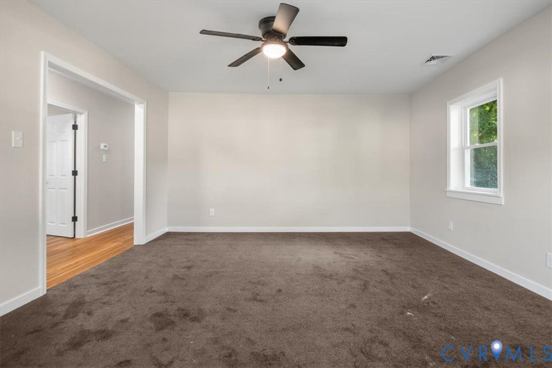 Recessed window, ceiling fan with integrated lighting, and neutral wall tones