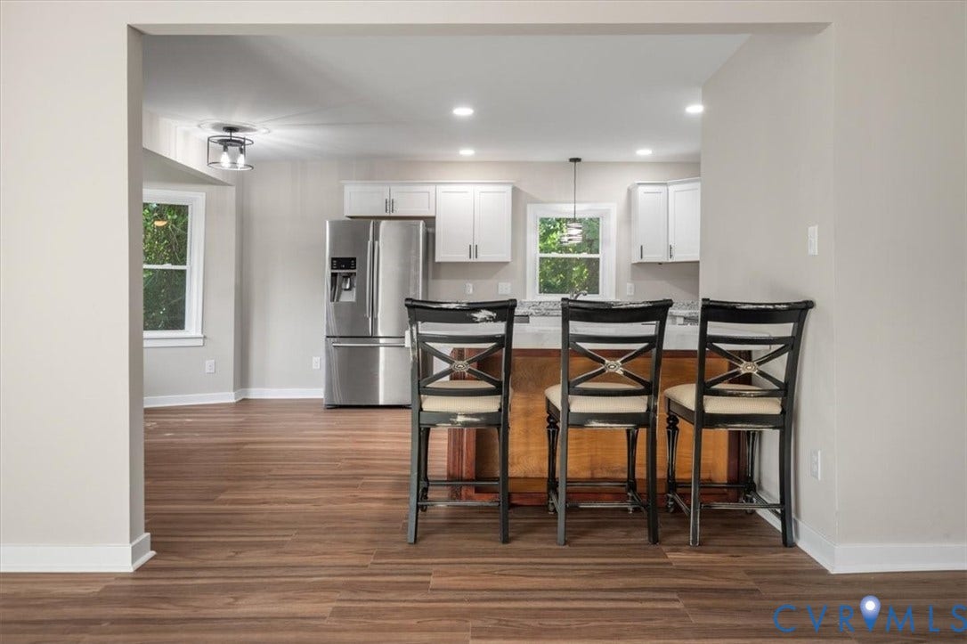 Open concept living area with wood-finish flooring