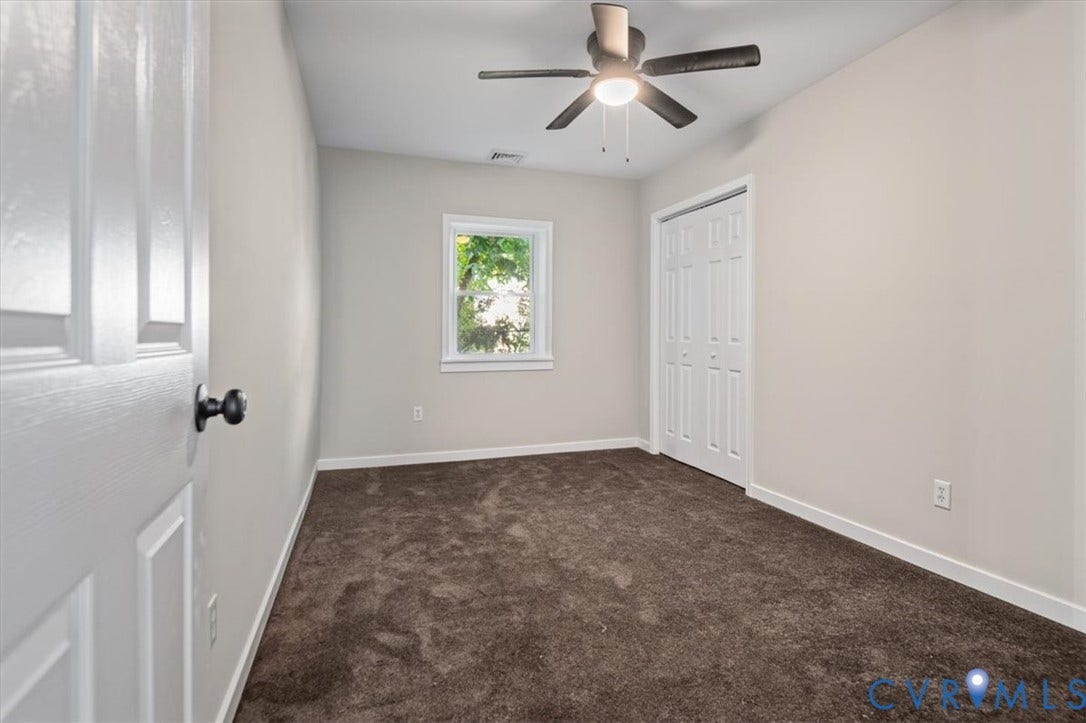 Recessed window, ceiling fan with integrated lighting, bi-fold closet doors, and plush carpeting