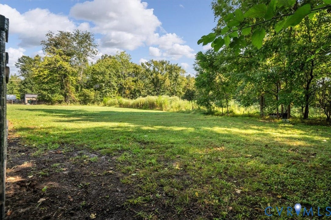 Expansive grassy area with mature perimeter trees