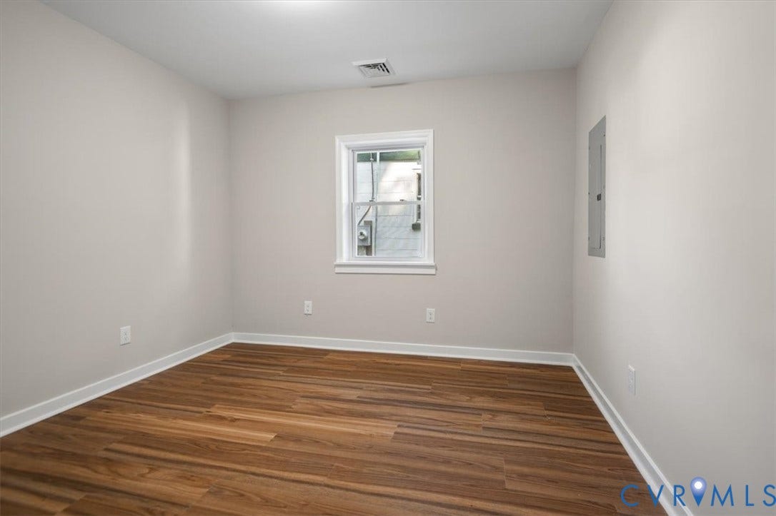 Neutral-toned walls with wood-finish flooring