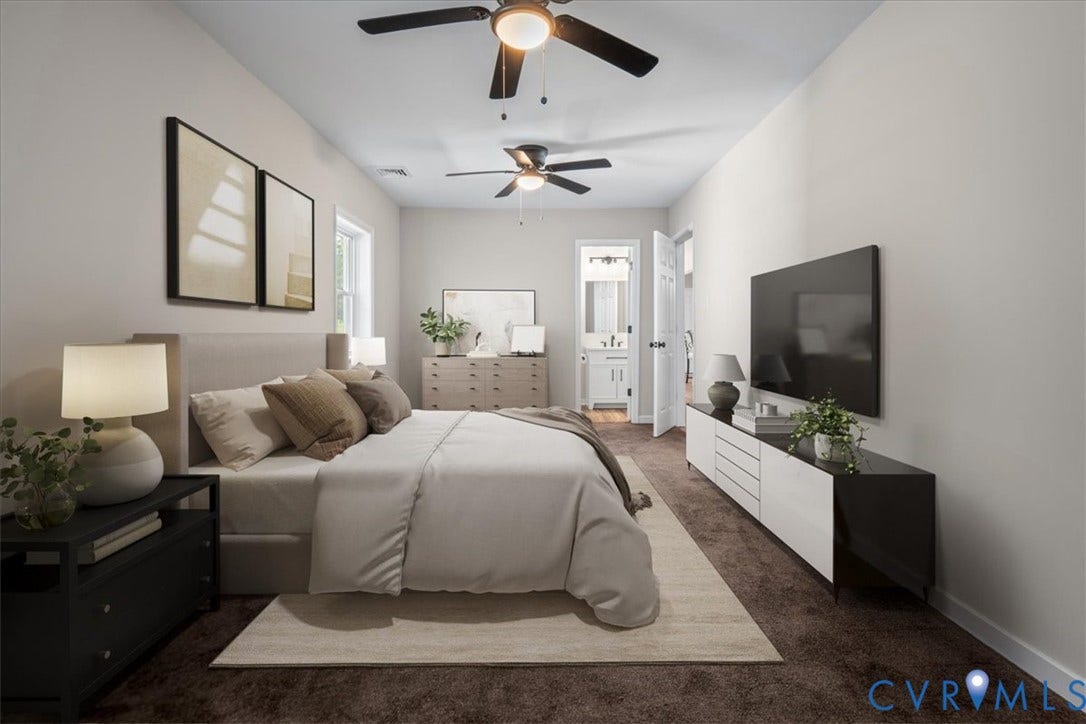 Spacious room featuring ceiling fans, a window with natural light, and plush carpeting