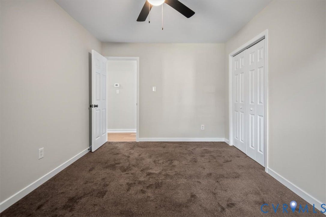 Neutral-toned walls complement the brown carpeting