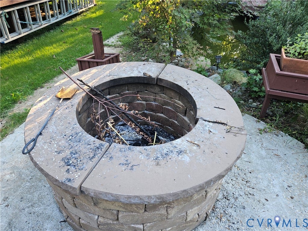 Stone block fire pit with a brick-lined interior